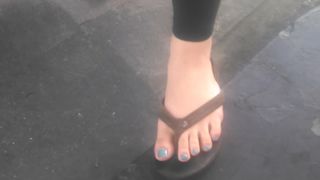 Asian cutie shows her feet at the gasstation