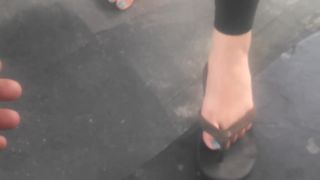 Asian cutie shows her feet at the gasstation